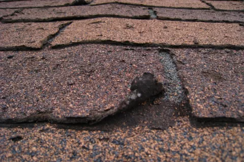 Curling shingles. Reroofing shingles.