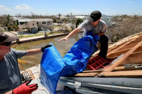 Tarp on shingle roof during seasons