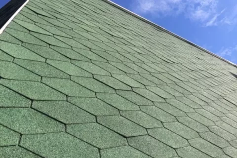 Buckled shingles on façade due to installation error failure