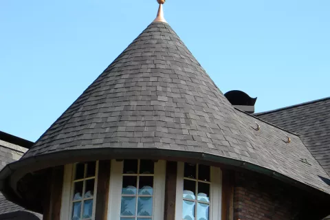 Metal cap on cone shapred roof detail