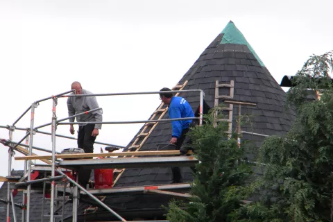Scaffolding around shingle roof